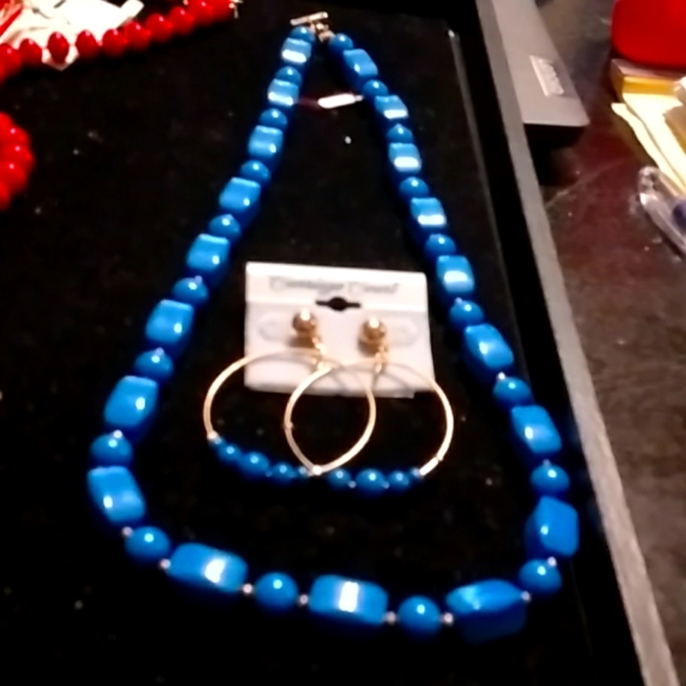 Pretty blue bead necklace and golden hoop earrings with blue beads